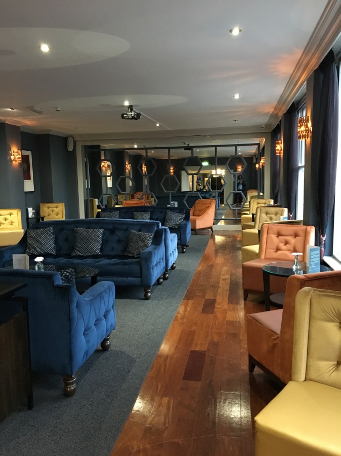 hotel lounge with yellow and blue chairs