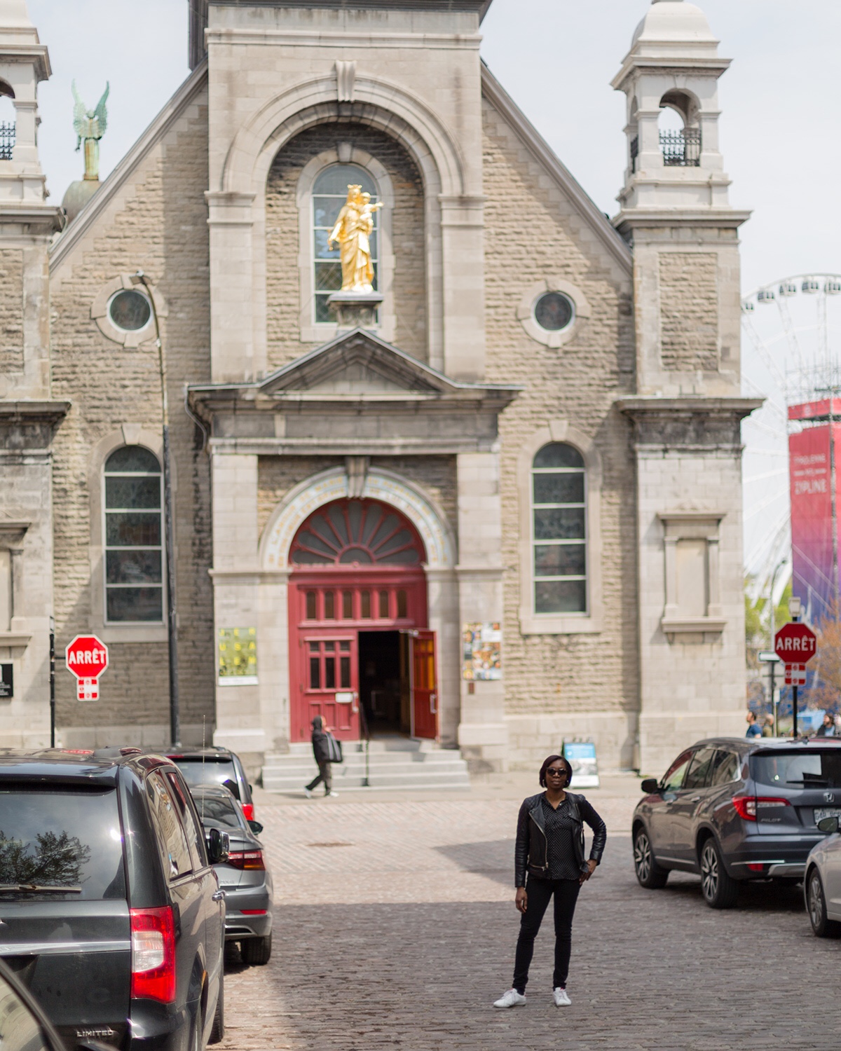 Woman standing in front of Notre Dame Of Bonsecours Chapel