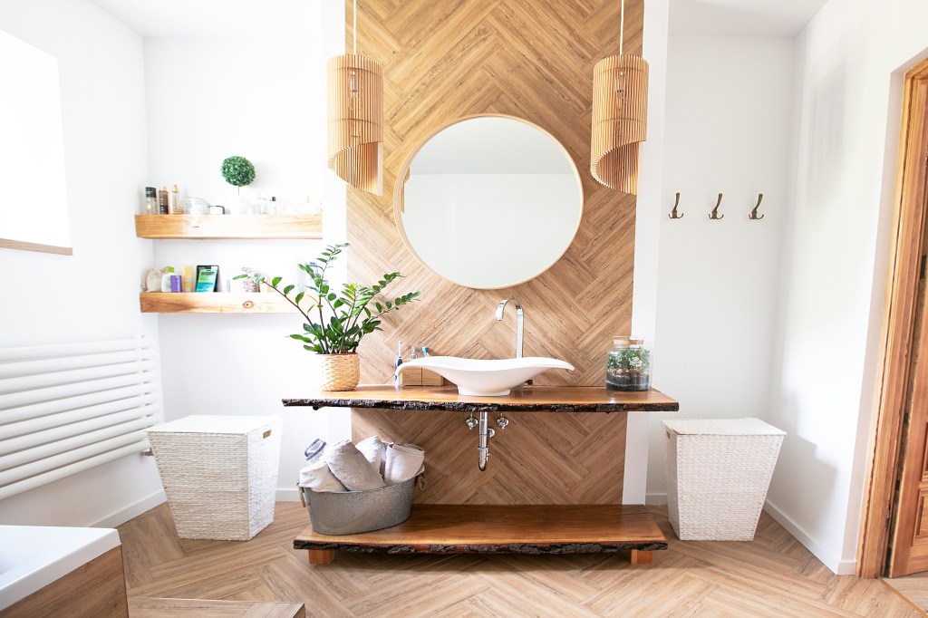Sleek, clean and modern bathroom with natural wood and white and plants.