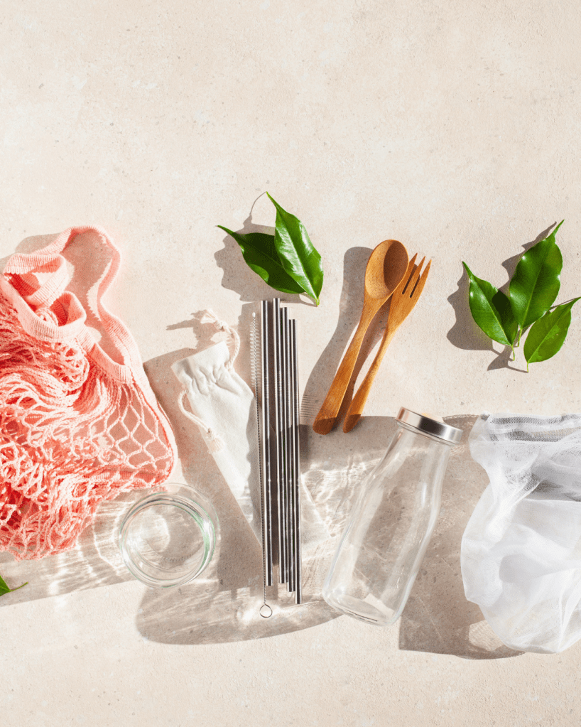 Recyclable cutlery, metal straws, glass bottles and mesh reusable bag.